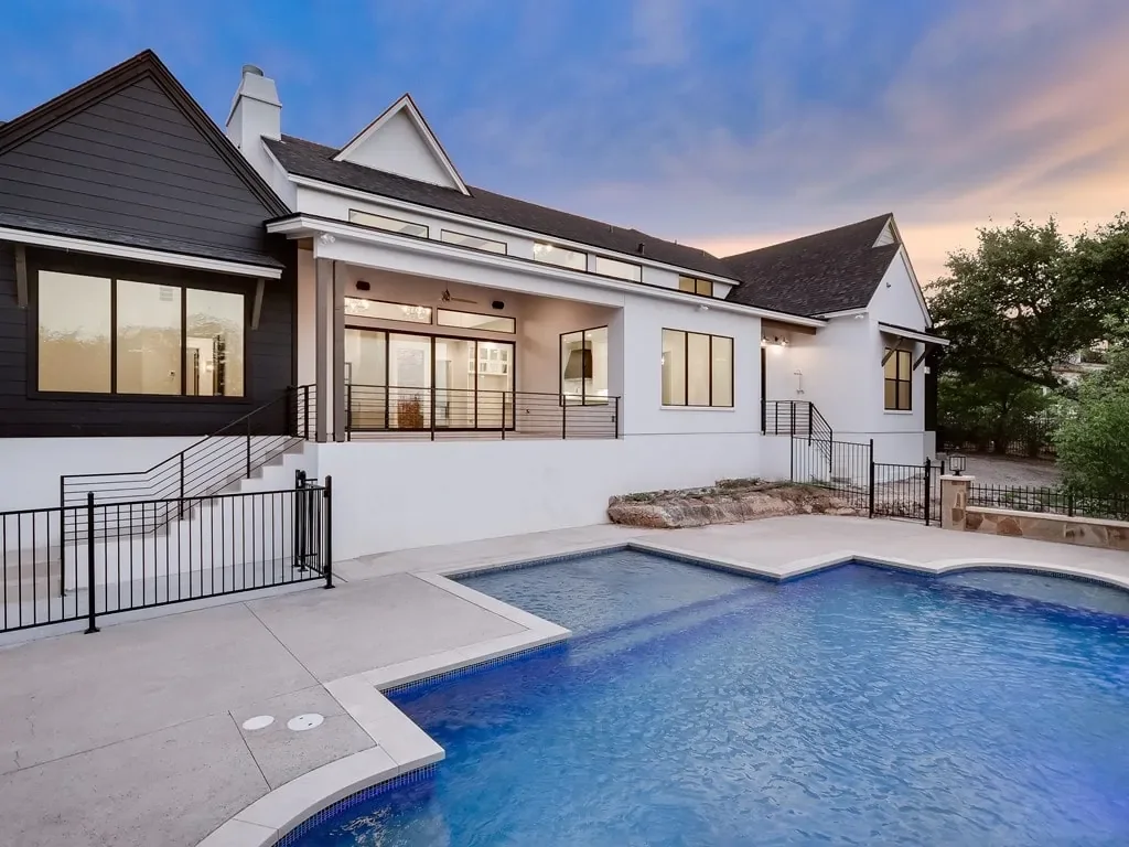 white exterior with black trim and pool