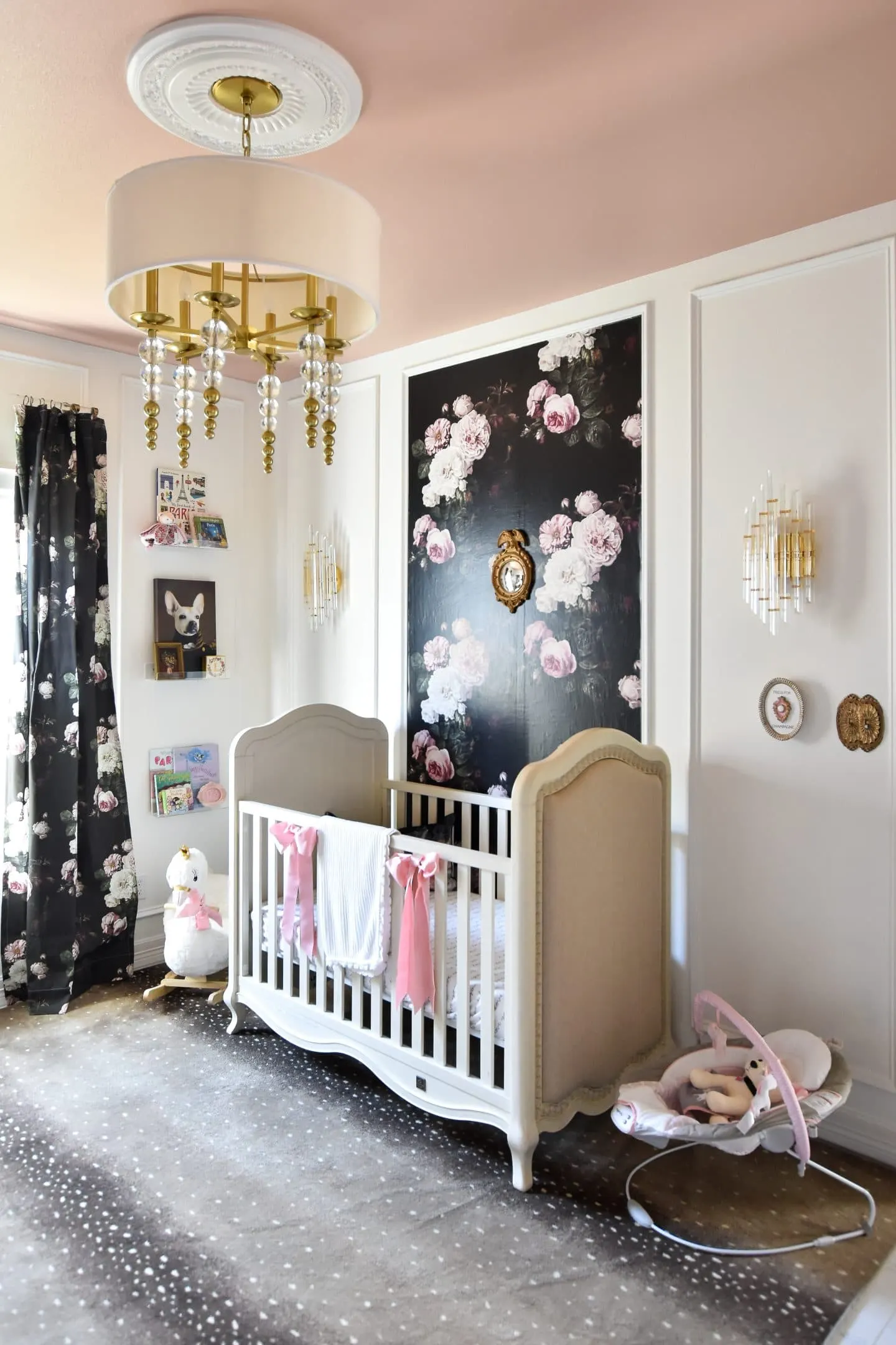 A modern French baby girl nursery with moody florals, antique and thrifted furniture and decor plus lots of budget-friendly DIY ideas.