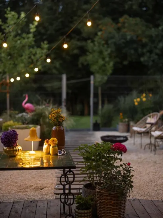 Pea gravel patio with outdoor cafe string lights